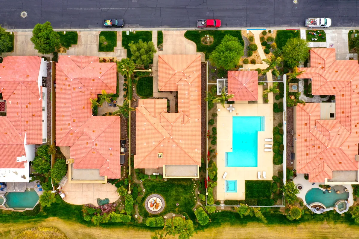 Air Concierge alternatives for Airbnb owners, Aerial view of red-tiled villas with private pools and garden courtyards