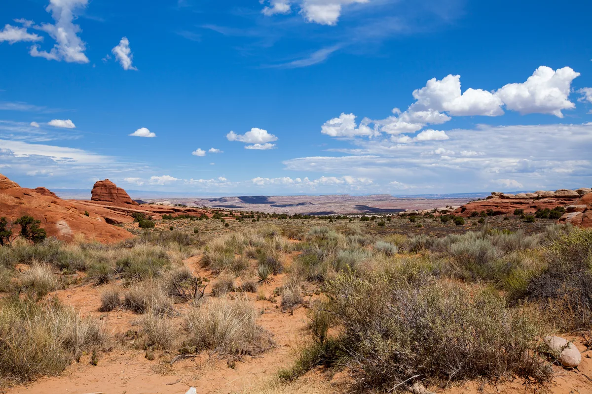 Utah's Best Vacation Rentals alternatives for Airbnb owners, Red rock desert with sagebrush under a wide blue Utah sky