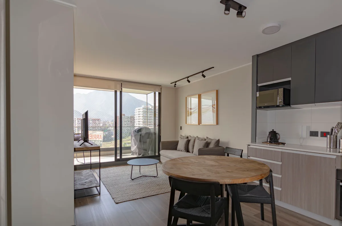 Guest Haus management fees, Furnished open-plan apartment with a dining table and a balcony over the