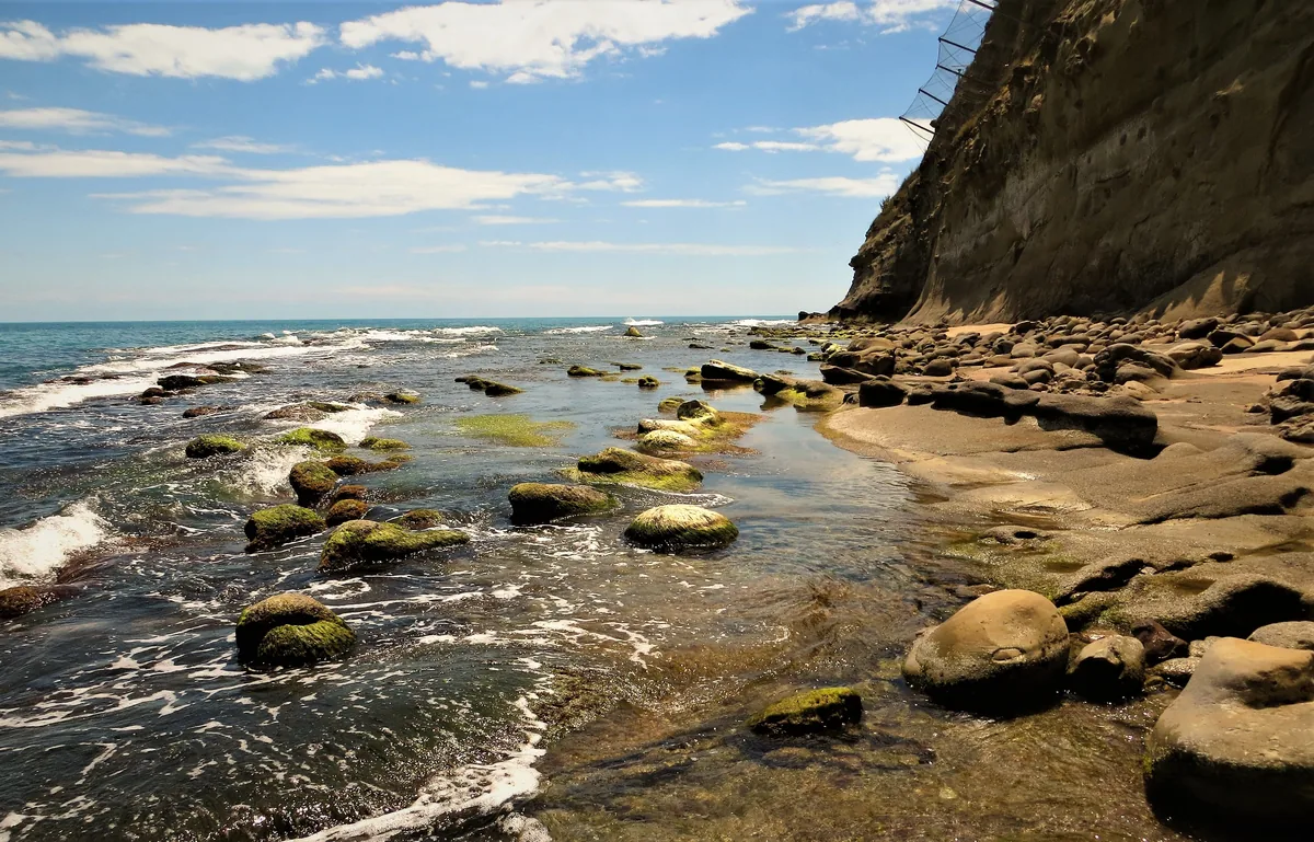 Bluewater Vacation Homes alternatives for Airbnb owners, Rocky tide pools and low sandstone cliffs on the Pacific shore