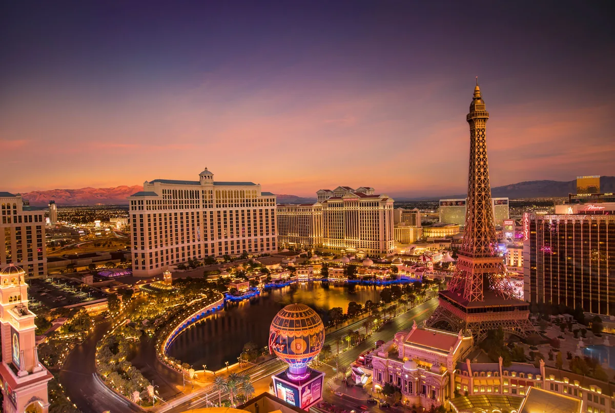5 Star STR management fees, Las Vegas resorts and their lakes glowing at dusk