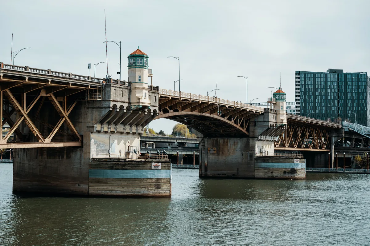 Descansa PDX management fees, Portland's Burnside Bridge crossing the Willamette River