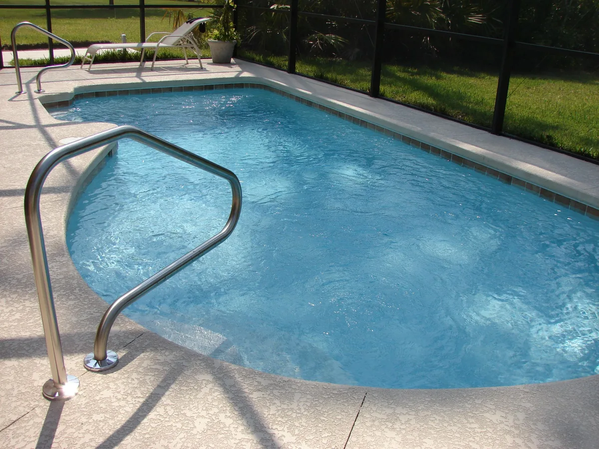 Global Resort Homes alternatives for Airbnb owners, Swimming pool with handrail inside a screened patio cage