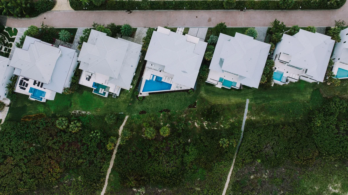 Global Resort Homes management fees, Aerial view of a row of Florida houses each with its own pool