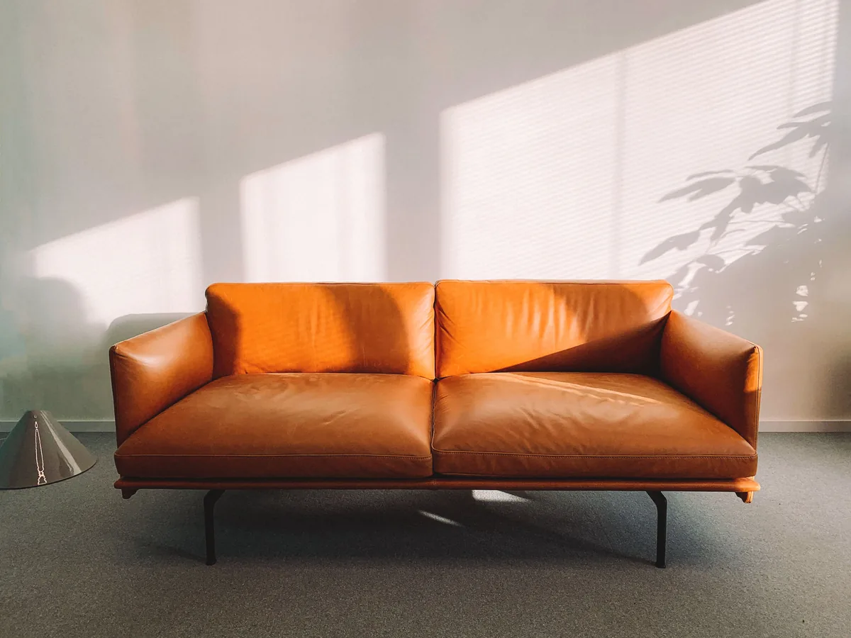 Goldnest management fees, Leather sofa in a furnished rental interior