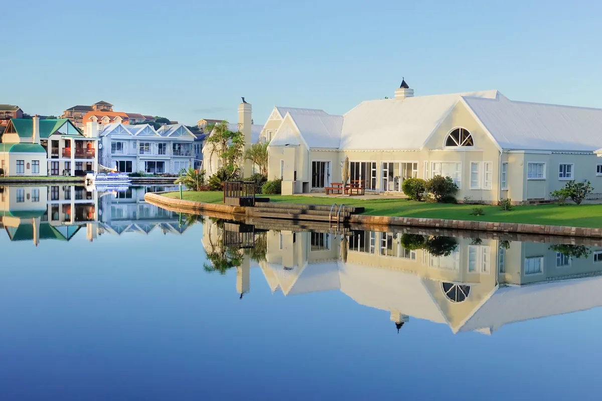 Goldnest alternatives for Airbnb owners, Waterfront homes reflected in still water