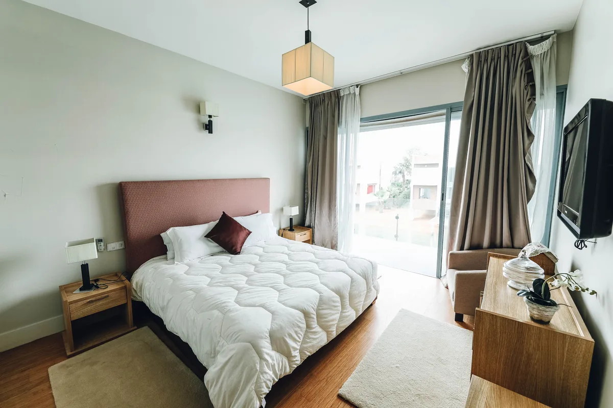 Twinity Properties management fees, Bedroom with balcony doors in a rental apartment