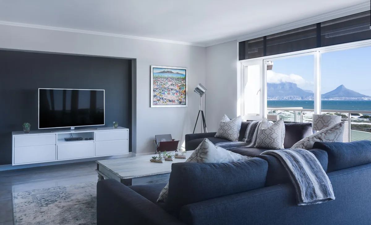 MasterHost management fees, Living room with a coastal view in a serviced rental