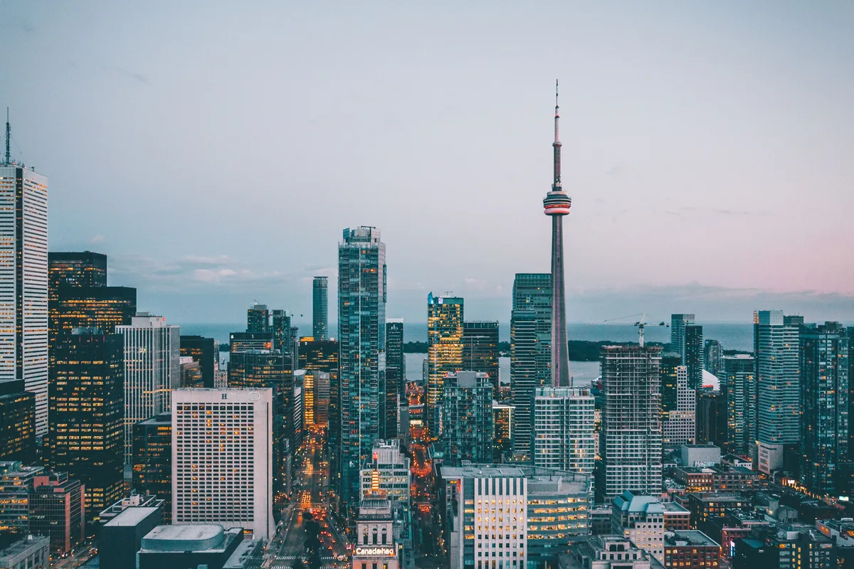 RedAwning alternatives for Airbnb owners, City skyline with a tall communications tower at dusk