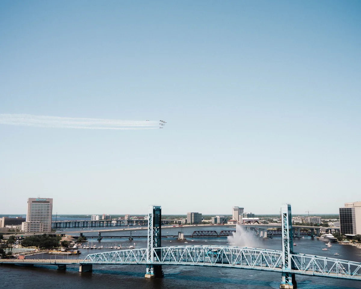 JaxBNB alternatives for Airbnb owners, Jacksonville's lift bridges crossing the river below a wide sky