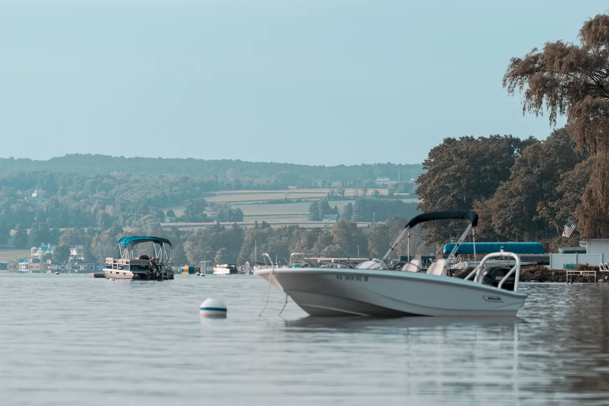 FLX Rentals alternatives for Airbnb owners, Motorboats moored on the lake below wooded hills