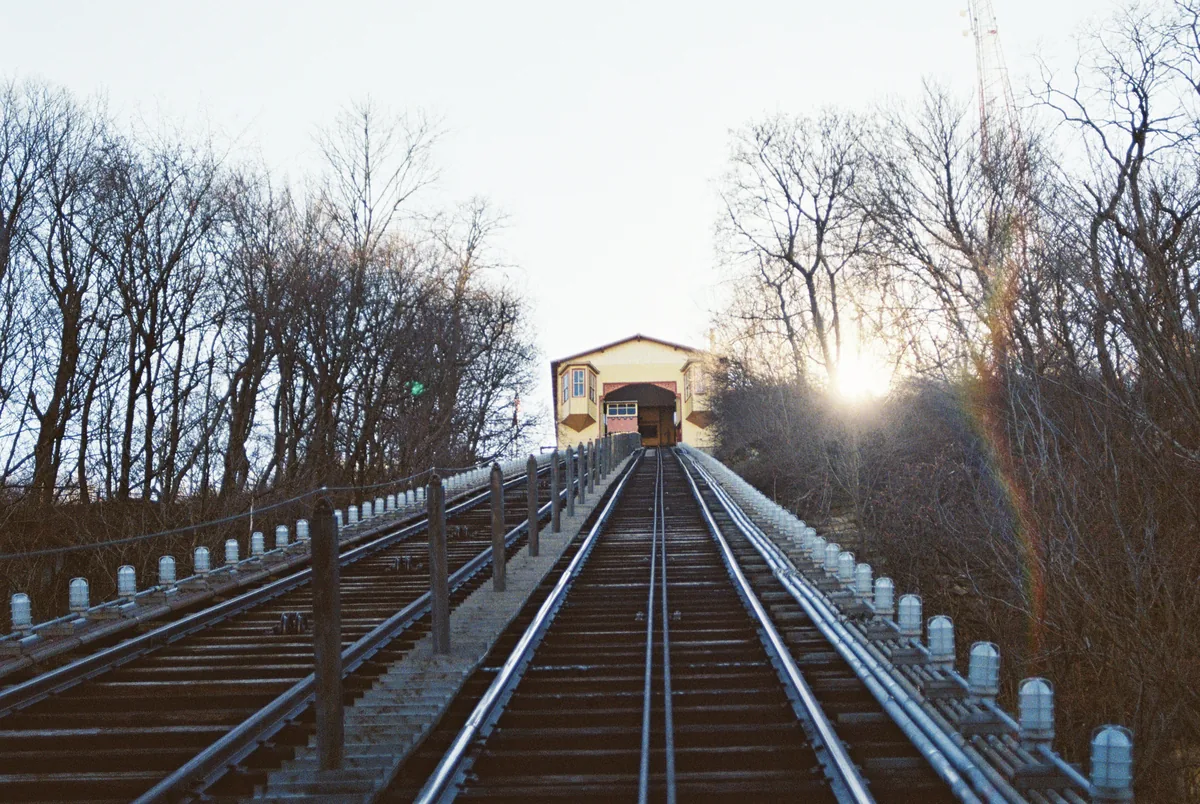 HostWise alternatives for Airbnb owners, Incline railway tracks running up the slope into the sunset