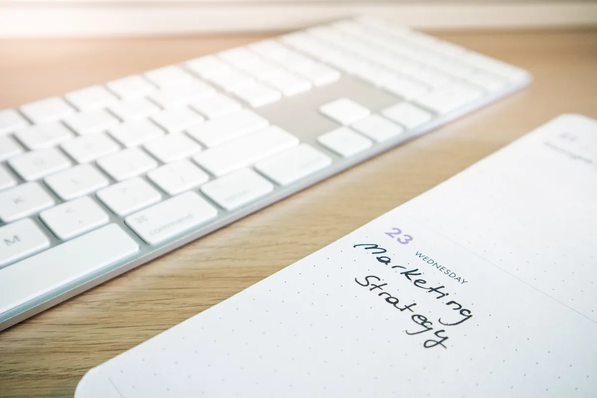 Boring Host alternatives for Airbnb owners, Notebook and keyboard on a wooden desk