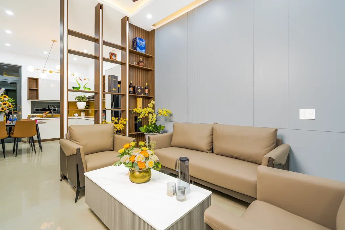 Living room with modern furniture and vibrant flowers enhancing the space
