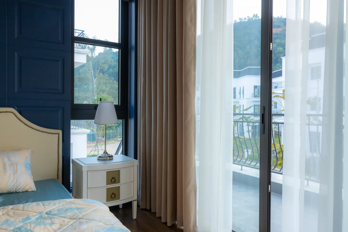Bedroom, blue wall, balcony doors — Vacation Rental Cleaning: The Ultimate Guide
