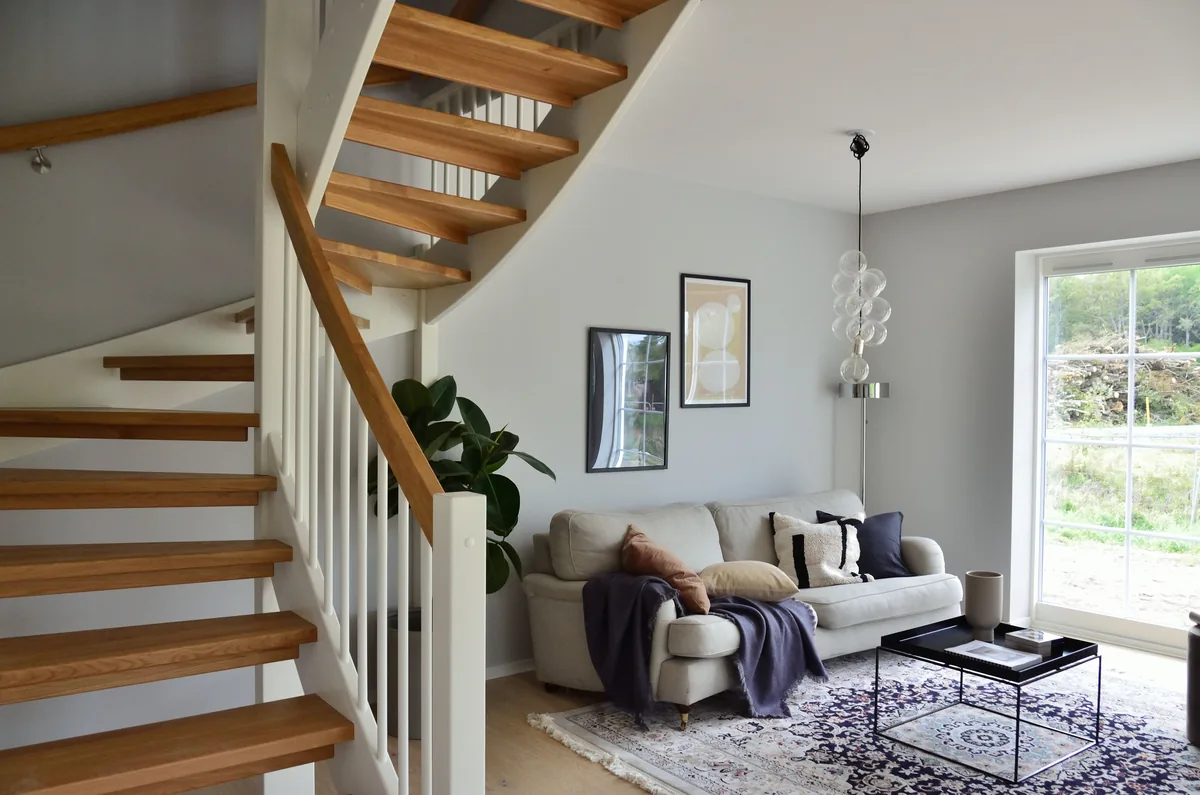 Living room beside an open staircase — Airbnb Co-Host: What It Is and How Co-Hosting Works