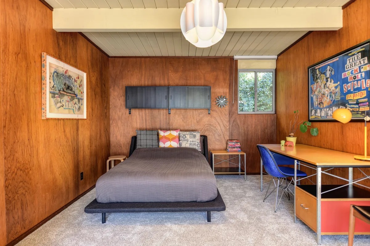 Mid-century bedroom with timber panelling — How Does Airbnb Work for Owners? Top 10 Questions Answered