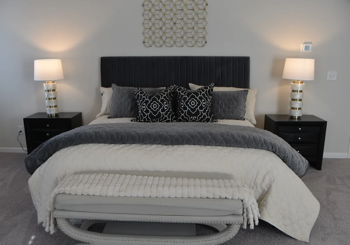 Grey bedroom with a dark headboard — Airbnb Guest Screening: How to Vet Guests and Protect Your Property