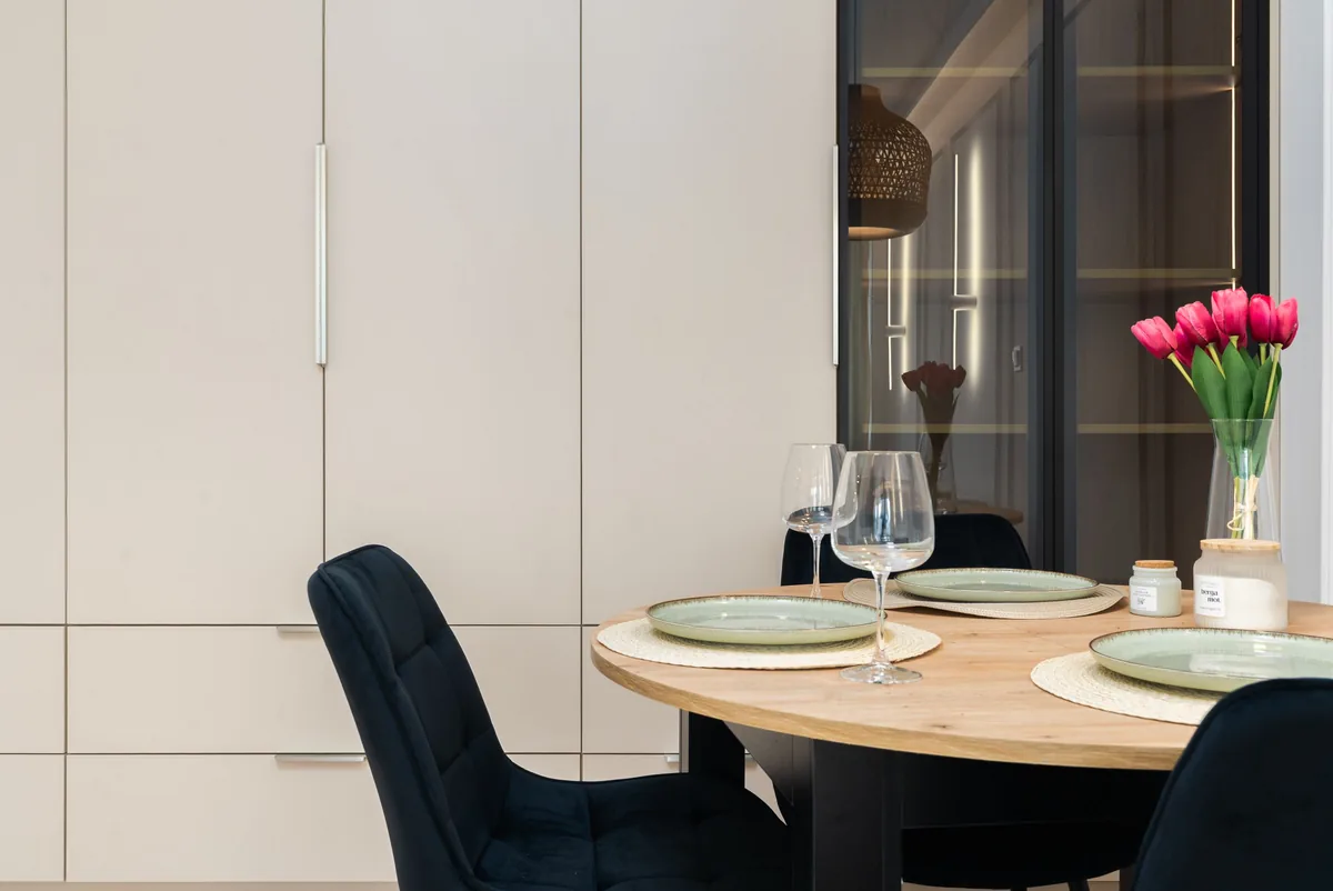 Round dining table laid for two — Airbnb Management Vancouver BC: Principal Residence Rules and 5 Companies