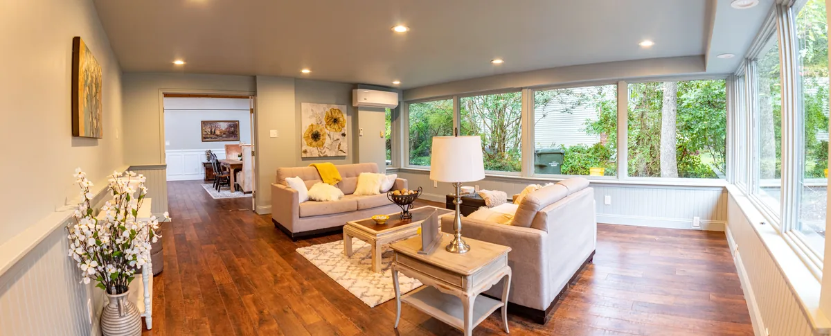 Living room wrapped in windows — Airbnb Management Fee: What Property Managers Charge in 2026