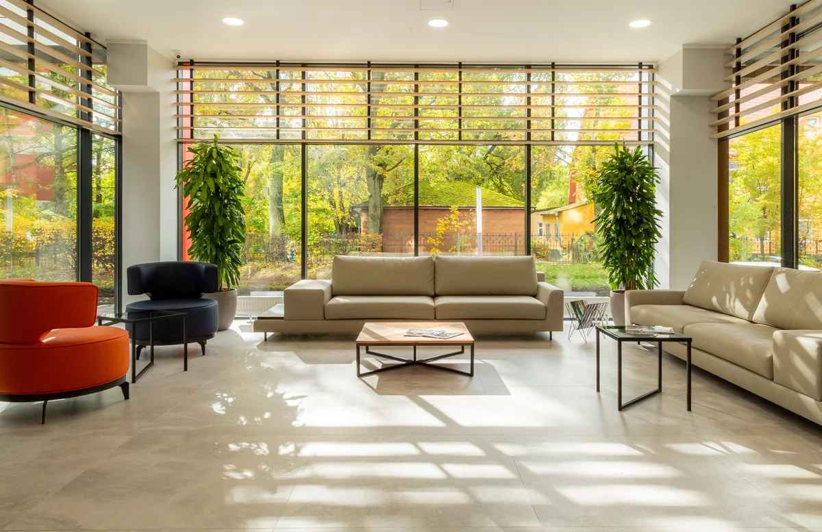 Living room behind floor-to-ceiling glass — Airbnb vs Hotel: Which Is Better, Cheaper and Worth Booking?
