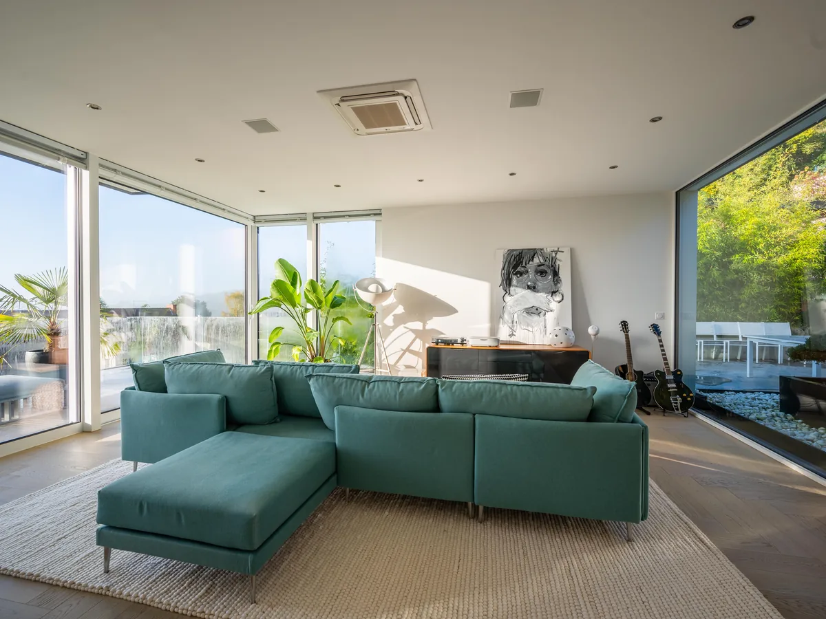 Teal sofa, garden beyond — Airbnb vs Hotel: Which Is Better, Cheaper and Worth Booking?