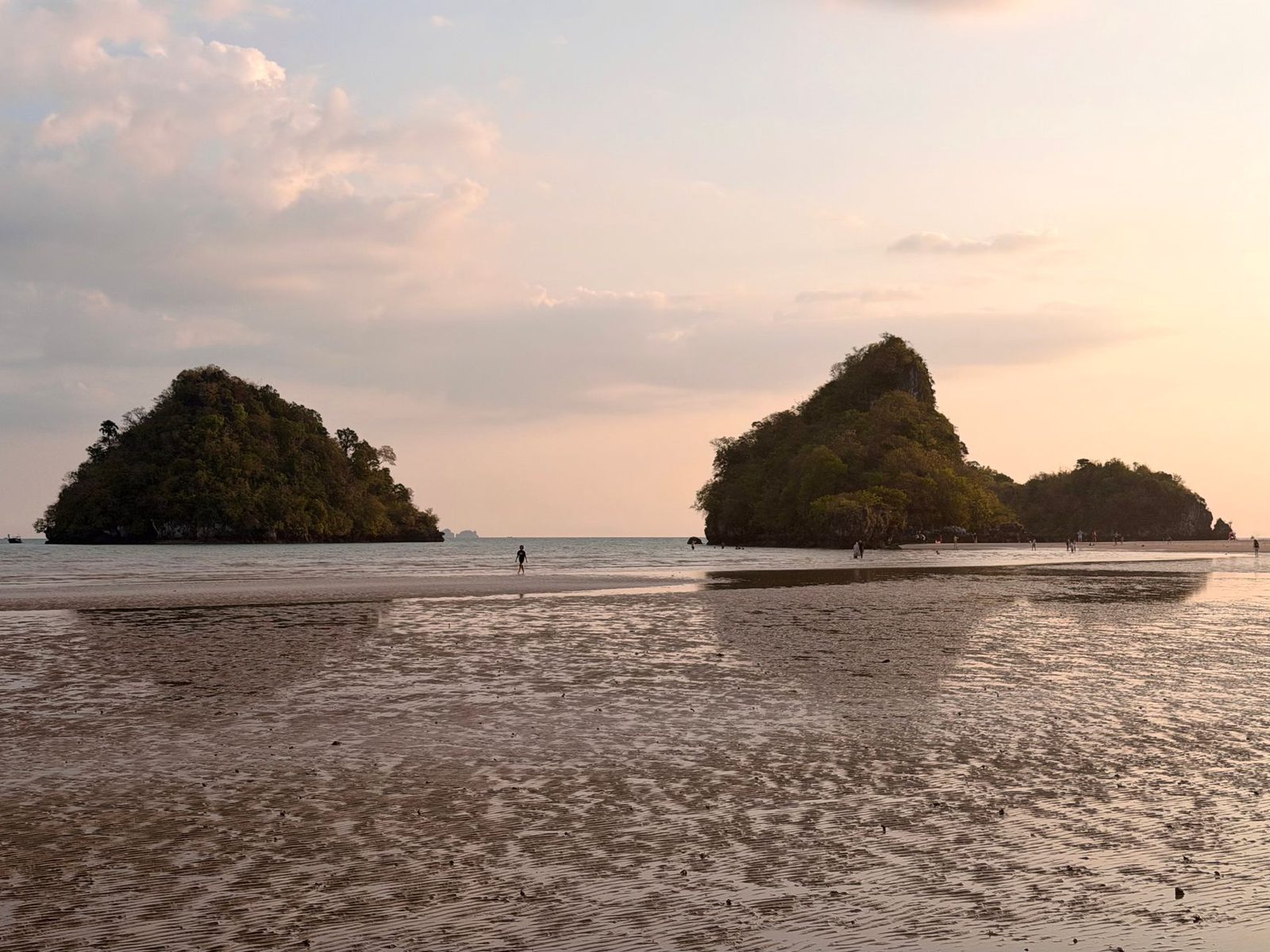 Two limestone islets on a tidal flat at sunset