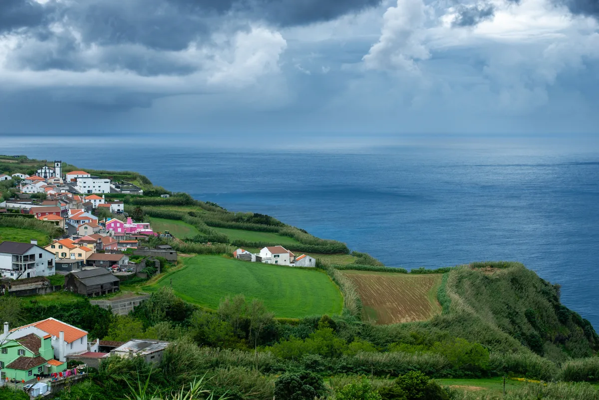 Vacation Home Management Azores alternatives Portugal, Azorean village among green farmland by the sea