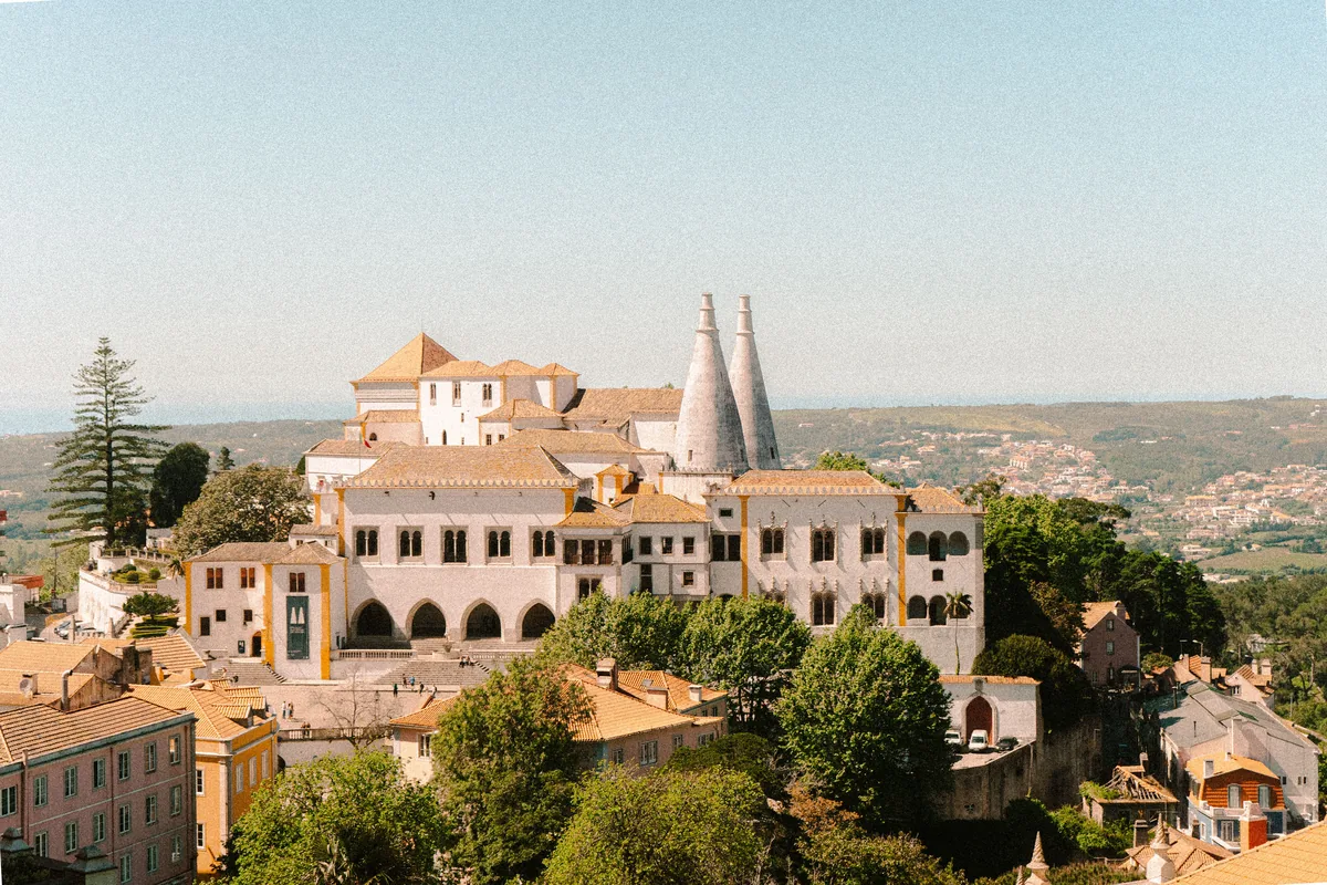 LovelyStay management fees, Sintra National Palace and its conical chimneys above the town