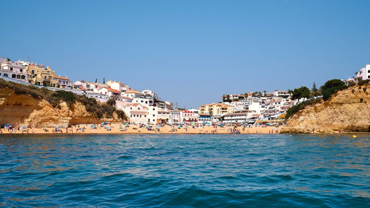 The Albufeira Concierge alternatives Portugal, Whitewashed Algarve houses on the cliff above a cove