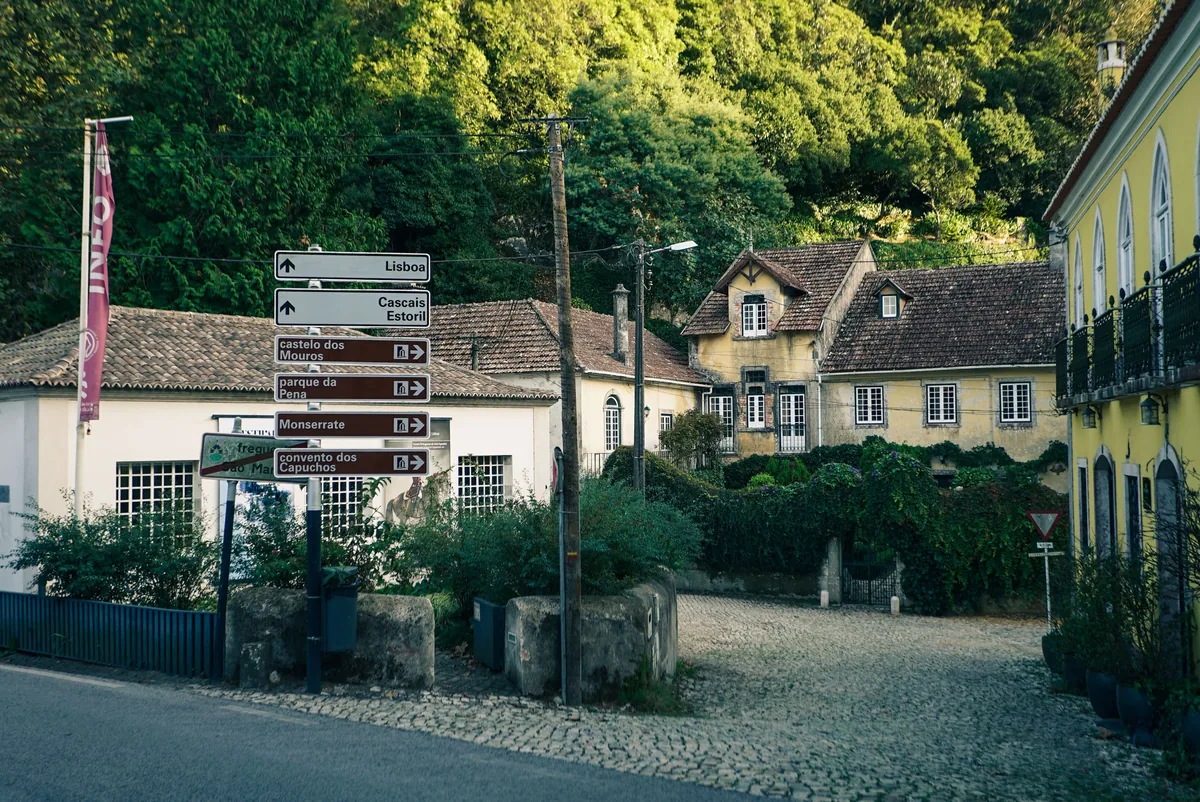 Homeful alternatives Portugal, Quiet street of painted houses below wooded hills