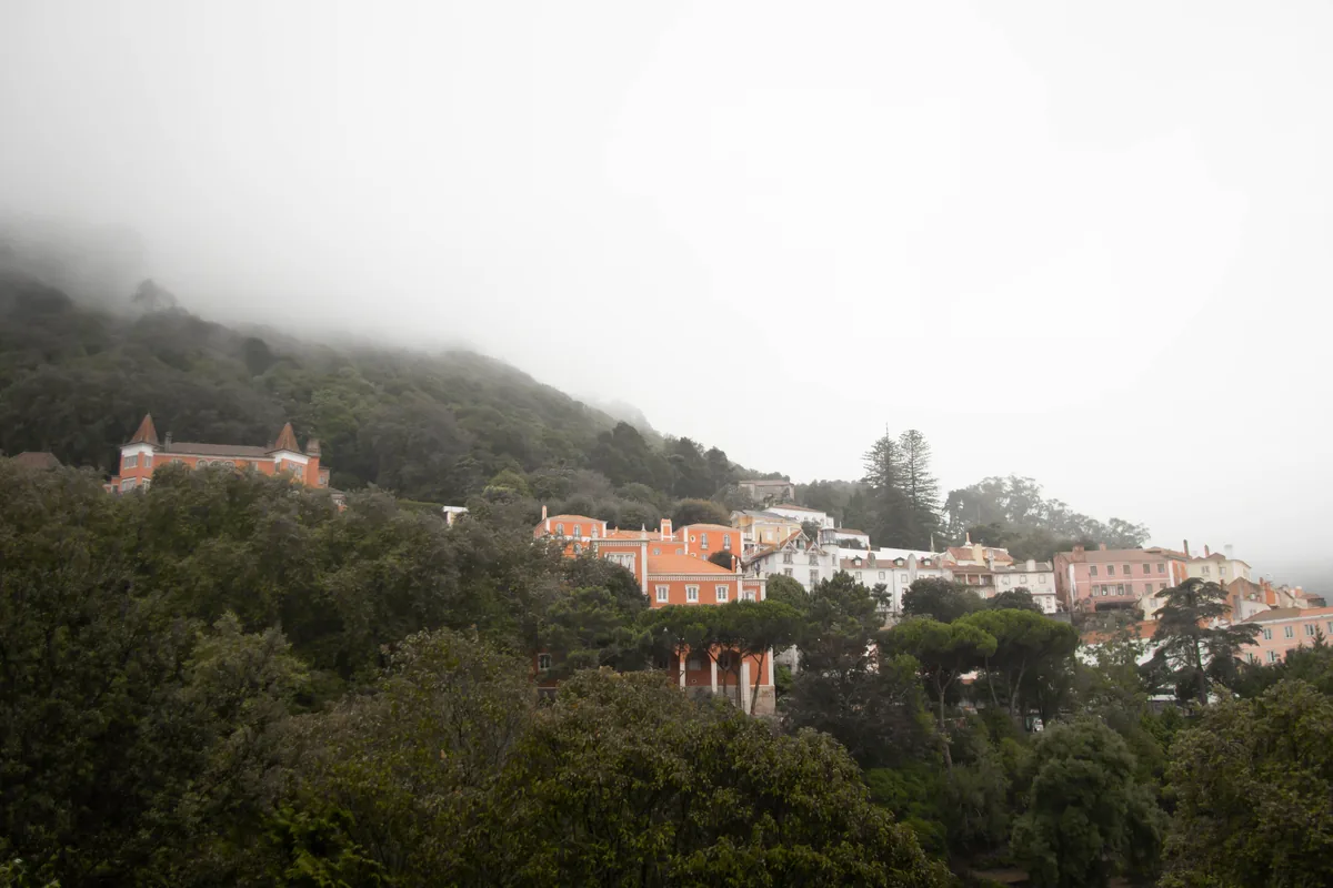 Homeful management fees, Hillside village under low cloud