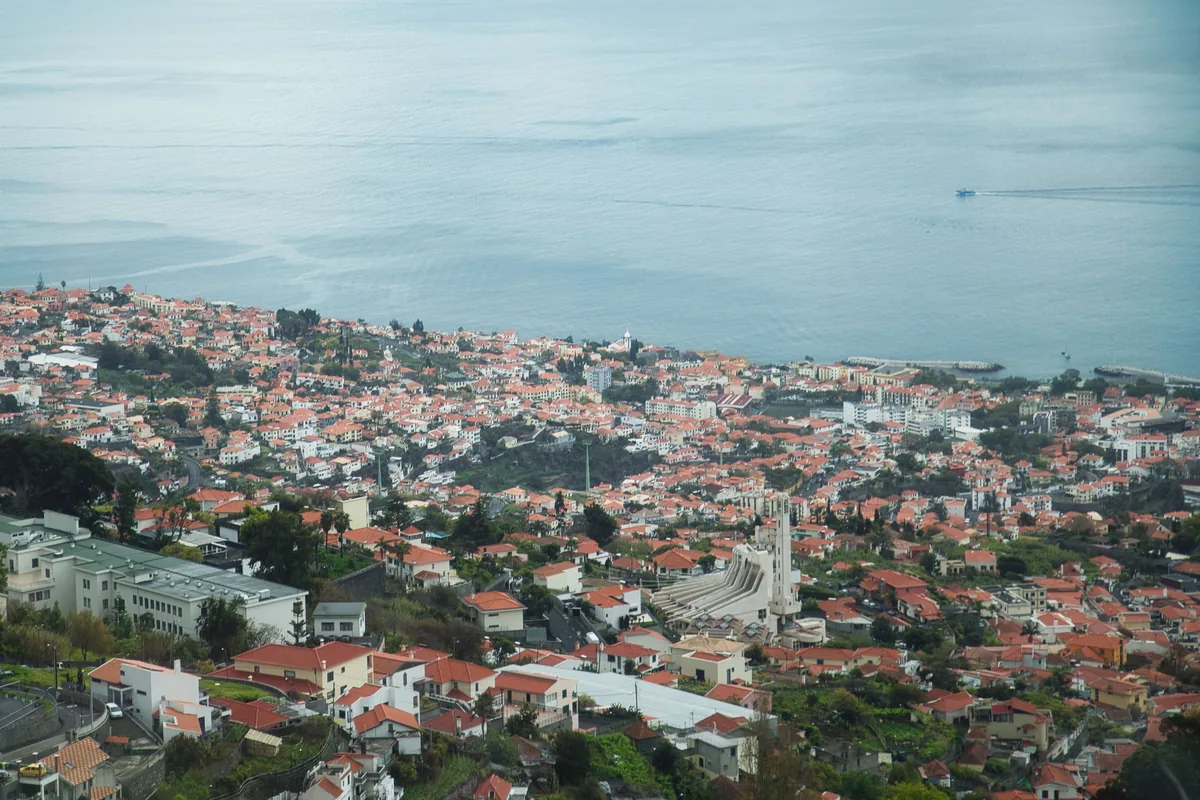 Off Limits Madeira alternatives Portugal, Red-roofed Madeira houses climbing the slope