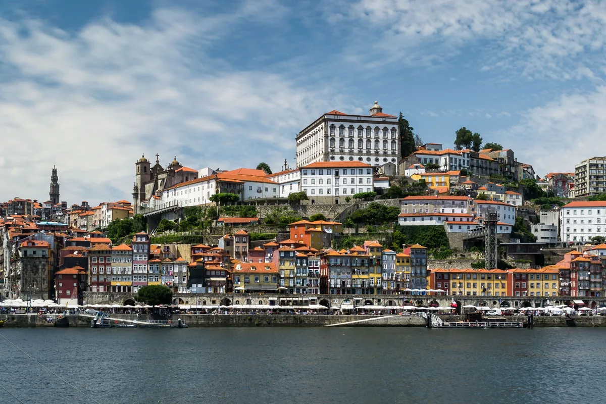 SuperAnfitrioes management fees, Colourful Porto waterfront houses seen from the river