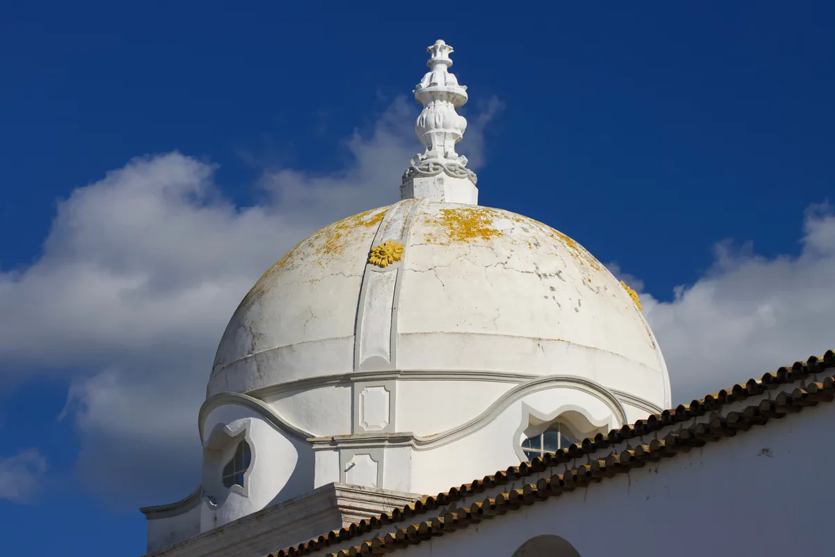 Enjoy Your Stay alternatives Portugal, White church dome against a blue sky in the Algarve