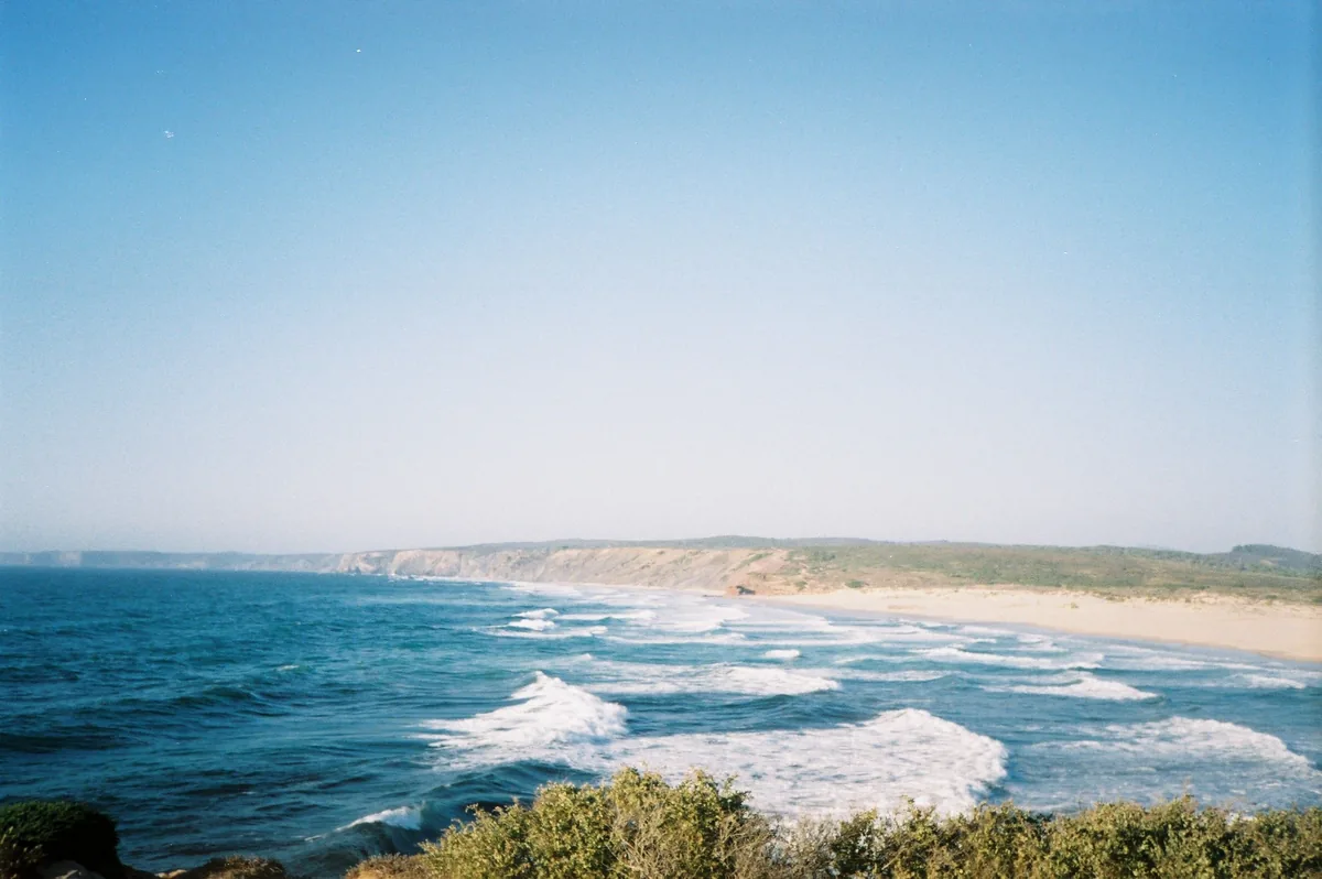 Gest4Hotel alternatives Portugal, Waves breaking below a green Alentejo headland
