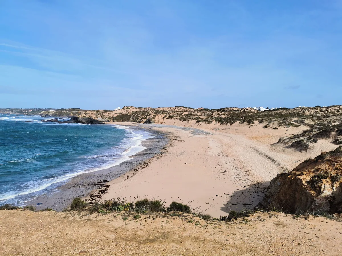 Airnest REIM alternatives Portugal, Sandy cove backed by dunes on the Alentejo coast