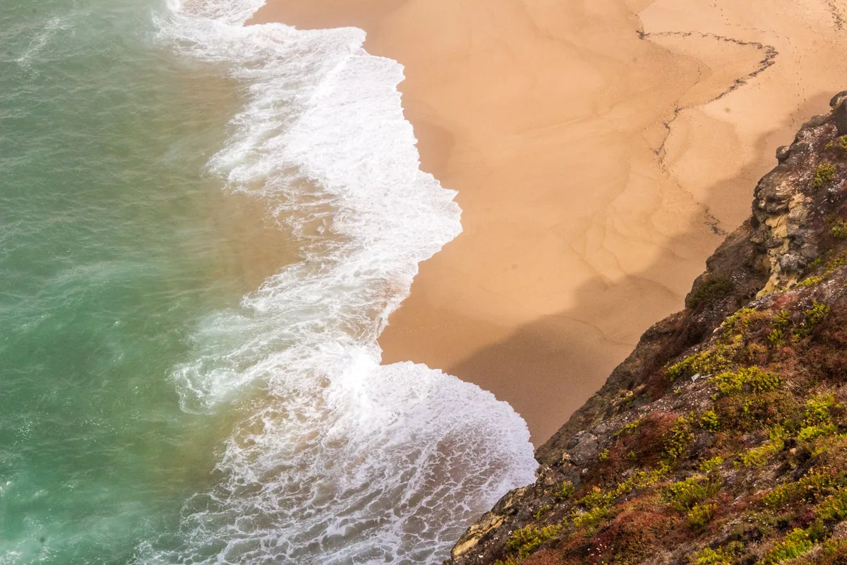SmartHomes alternatives Portugal, Aerial view of surf against the Nazare cliffs