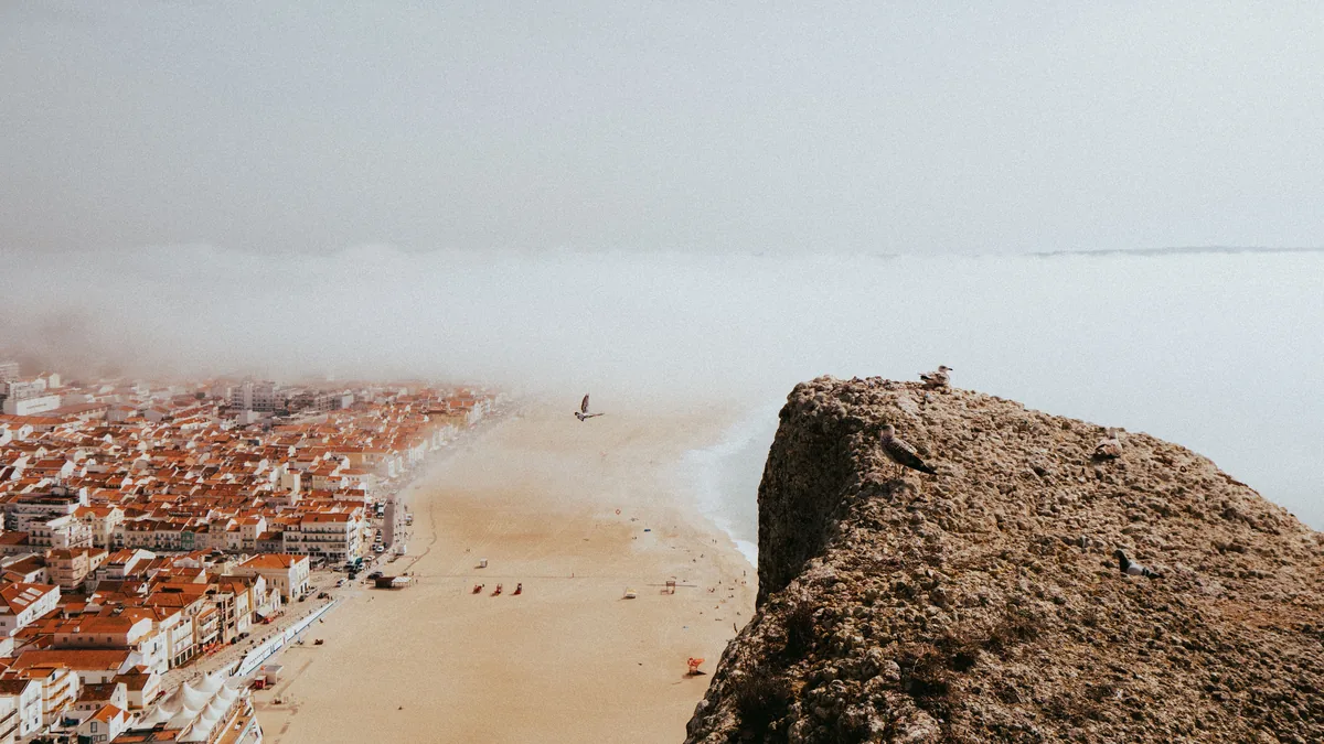 Gest2Easy alternatives Portugal, Nazare beach and rock with the town behind