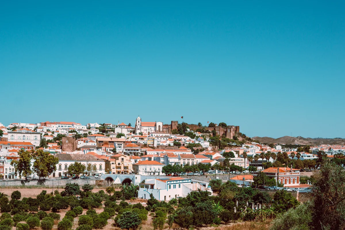 Vista Algarve management fees, White houses of Silves on the hillside above orange groves