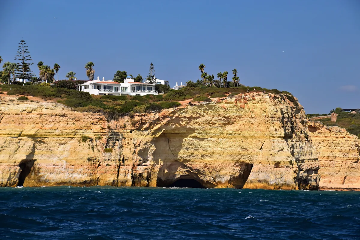 Villas along the clifftop above the Algarve's ochre sea cliffs