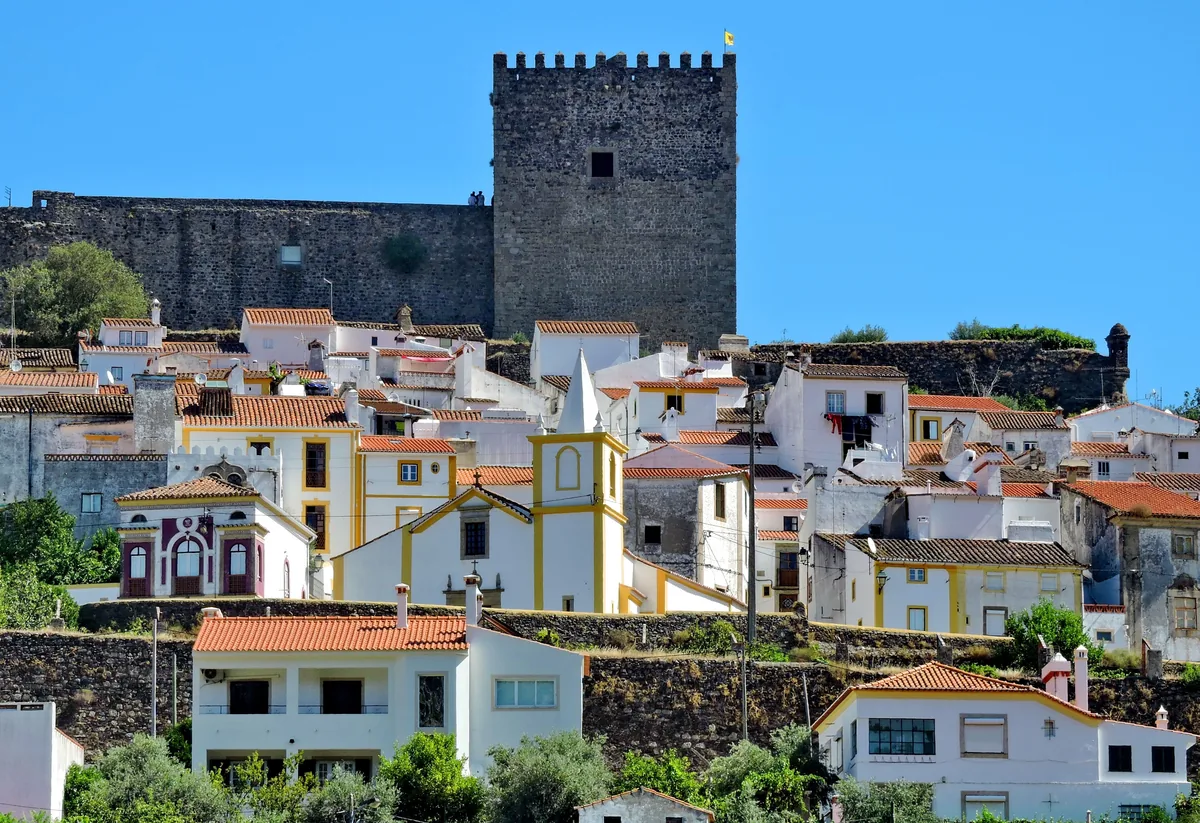 A fortified keep above the white and ochre houses of an Alentejo hill town