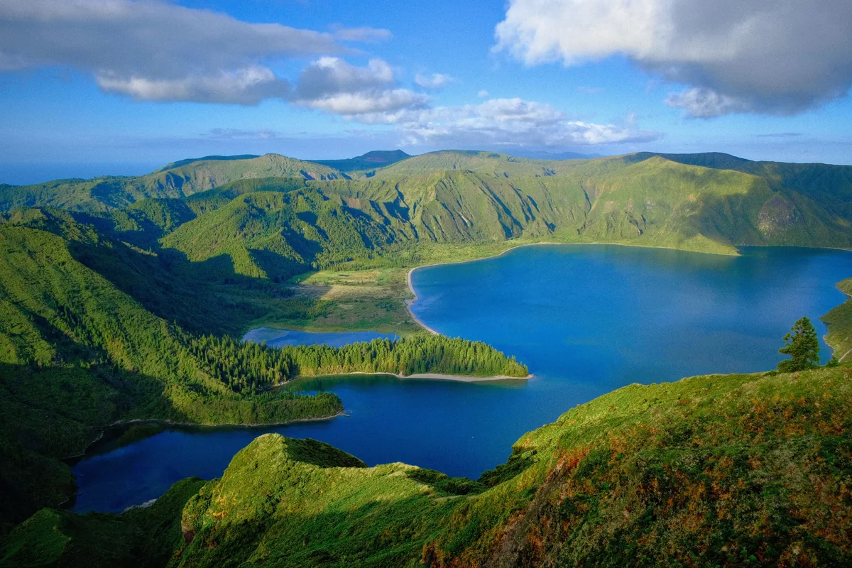 A deep blue crater lake among green hills on Sao Miguel