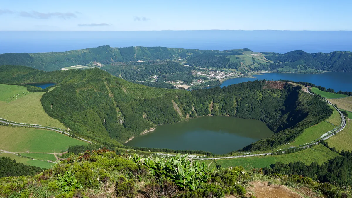 A crater lake below cultivated slopes in the Azores