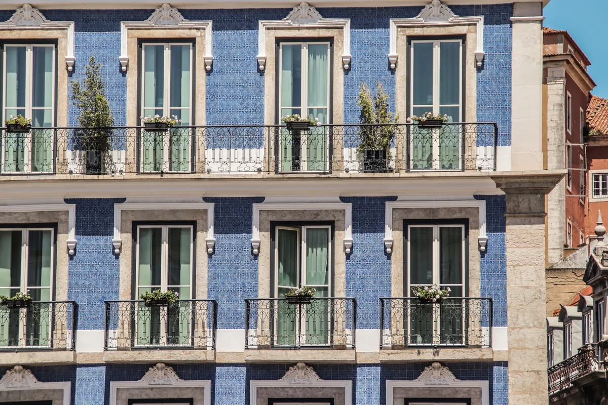 A tiled Portuguese facade with wrought-iron balconies