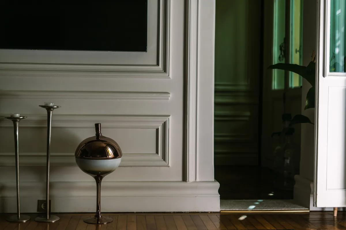A furnished interior with wooden floors and panelled walls
