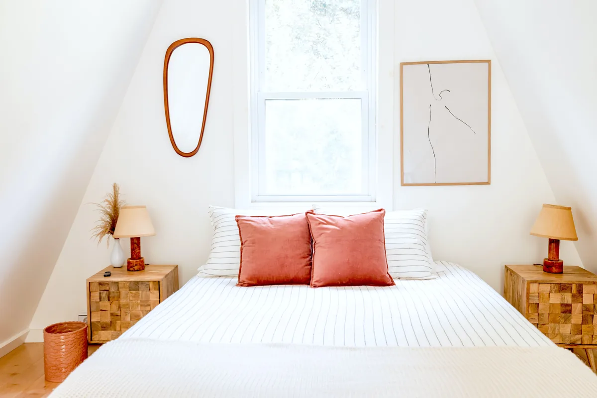 A bright attic bedroom under the eaves of a let property