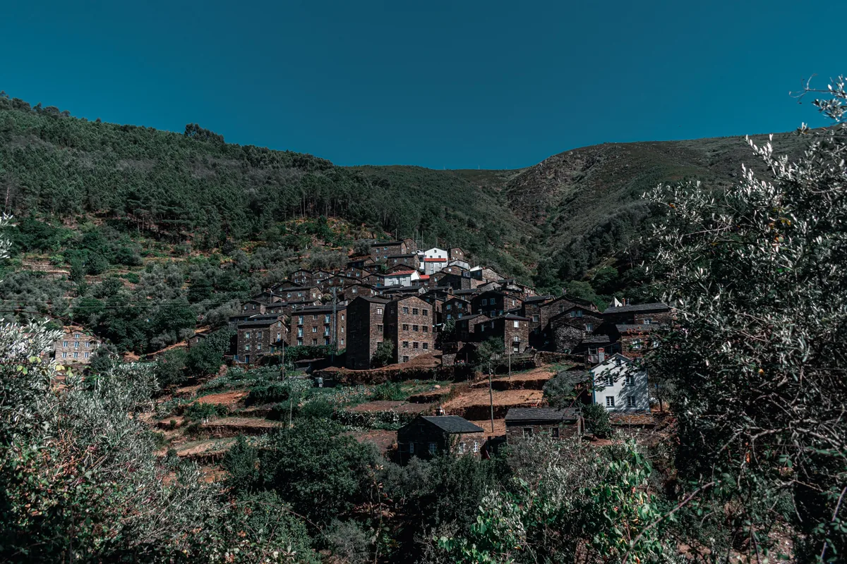A mountain village among wooded slopes in central Portugal
