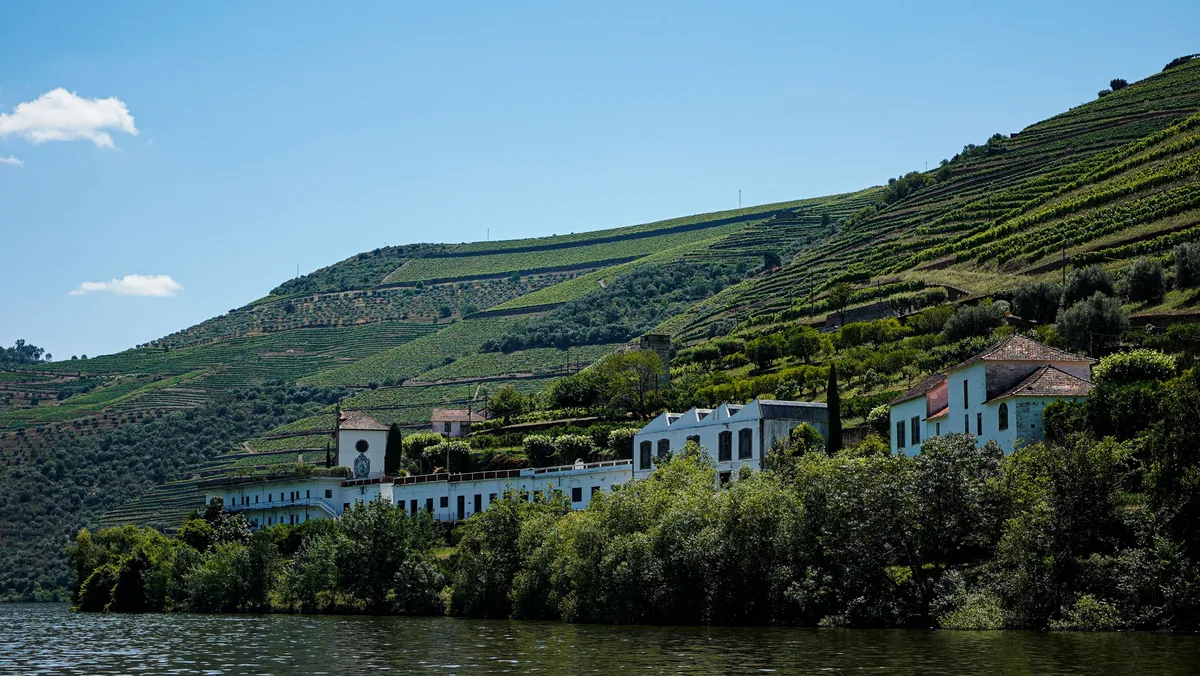 A riverside quinta below terraced vineyards in the Douro Valley