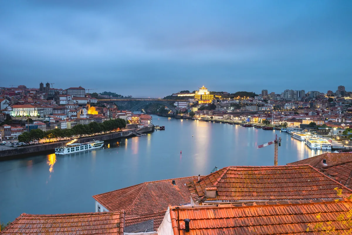 Porto and the Douro at twilight, seen over terracotta rooftops